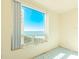 Bedroom with large window offering stunning ocean view at 1180 Gulf Blvd # 1603, Clearwater Beach, FL 33767