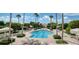 Inviting community pool surrounded by palms at 1180 Gulf Blvd # 1603, Clearwater Beach, FL 33767