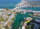 Aerial view of waterfront property with boat slips and nearby bridge at 12482 Capri N Cir # 4, Treasure Island, FL 33706