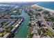 Wide aerial showcasing coastal town, waterfront homes, and beautiful beach at 12482 Capri N Cir # 4, Treasure Island, FL 33706