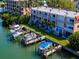 Aerial view of waterfront property with boat slips and a two-story building at 12482 Capri N Cir # 4, Treasure Island, FL 33706