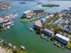 Wide aerial view of canal front property with multiple buildings and boat docks at 12482 Capri N Cir # 4, Treasure Island, FL 33706