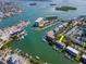 Close-up aerial of waterfront condo building with boat slips and tropical foliage at 12482 Capri N Cir # 4, Treasure Island, FL 33706