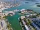 Aerial perspective showcasing waterfront property, marina, and surrounding neighborhood at 12482 Capri N Cir # 4, Treasure Island, FL 33706