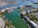 Aerial view showcasing waterfront property with private boat slips and lush landscape at 12482 Capri N Cir # 4, Treasure Island, FL 33706