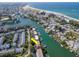 Aerial view highlighting waterfront location, building with boat slips, and beach at 12482 Capri N Cir # 4, Treasure Island, FL 33706