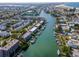 Aerial view showing waterfront community, boat docks, and nearby beach at 12482 Capri N Cir # 4, Treasure Island, FL 33706