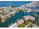 Aerial view showing waterfront property with boat docks and a beautiful beach at 12482 Capri N Cir # 4, Treasure Island, FL 33706