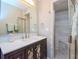 Updated bathroom with a dark vanity and a shower at 12482 Capri N Cir # 4, Treasure Island, FL 33706