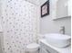 Clean bathroom with white vessel sink, gray vanity, and polka dot shower curtain at 12482 Capri N Cir # 4, Treasure Island, FL 33706