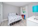 Cozy bedroom with a white metal bed frame and colorful storage at 12482 Capri N Cir # 4, Treasure Island, FL 33706