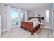 Spacious bedroom with a wooden sleigh bed and water views at 12482 Capri N Cir # 4, Treasure Island, FL 33706
