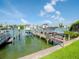 Private boat dock with two boat lifts and waterfront views at 12482 Capri N Cir # 4, Treasure Island, FL 33706