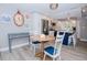 Charming dining area with a round wooden table and blue chairs at 12482 Capri N Cir # 4, Treasure Island, FL 33706