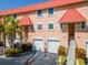 Attractive two-story condo with red tile roofs, attached garages, and landscaped grounds at 12482 Capri N Cir # 4, Treasure Island, FL 33706