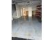 Unfinished garage with epoxy floor and ample storage shelving at 12482 Capri N Cir # 4, Treasure Island, FL 33706