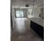 Open concept kitchen and living area with modern flooring and stainless steel appliances at 12482 Capri N Cir # 4, Treasure Island, FL 33706