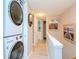 Stackable washer and dryer in a laundry area with hallway access at 12482 Capri N Cir # 4, Treasure Island, FL 33706