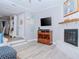 Living room features a fireplace, built-in shelving, and hardwood floors at 12482 Capri N Cir # 4, Treasure Island, FL 33706