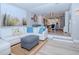 Bright living room with white sectional sofa, blue pillows, and a view into the kitchen at 12482 Capri N Cir # 4, Treasure Island, FL 33706