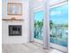 Cozy living room with fireplace, water views, and sliding glass doors to balcony at 12482 Capri N Cir # 4, Treasure Island, FL 33706