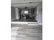 Spacious living room with open floor plan and modern laminate flooring at 12482 Capri N Cir # 4, Treasure Island, FL 33706