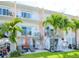 Ground level patio with outdoor furniture, lush landscaping, and canal views at 12482 Capri N Cir # 4, Treasure Island, FL 33706