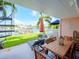 Covered patio with dining table, spiral staircase, and canal views at 12482 Capri N Cir # 4, Treasure Island, FL 33706
