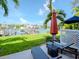 Relaxing patio with lounge chairs, umbrella, and waterfront views at 12482 Capri N Cir # 4, Treasure Island, FL 33706