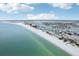 Aerial view of beachfront homes and clear water at 126 90Th Ave, Treasure Island, FL 33706
