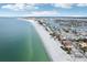 Aerial view of beachfront homes and clear water at 126 90Th Ave, Treasure Island, FL 33706
