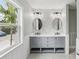 Double vanity bathroom with hexagon tile and gray cabinets at 126 90Th Ave, Treasure Island, FL 33706