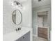 Single vanity bathroom with hexagon tile and gray cabinets at 126 90Th Ave, Treasure Island, FL 33706