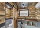 Rustic bathroom with wood walls and a barn door at 126 90Th Ave, Treasure Island, FL 33706