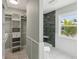 Bathroom with walk-in shower, tiled floors, and white vanity at 126 90Th Ave, Treasure Island, FL 33706
