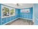 Bedroom with blue walls, wood floors, and window views at 126 90Th Ave, Treasure Island, FL 33706