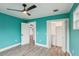Teal bedroom with wood floors and closet at 126 90Th Ave, Treasure Island, FL 33706