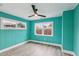 Teal bedroom with wood floors and ceiling fan at 126 90Th Ave, Treasure Island, FL 33706