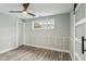 Bedroom with wood-look floors, barn door, and window looking out to backyard at 126 90Th Ave, Treasure Island, FL 33706