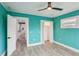 Teal bedroom with wood floors and access to kitchen at 126 90Th Ave, Treasure Island, FL 33706