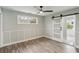Bedroom with wood-look floors, barn door, and window looking out to backyard at 126 90Th Ave, Treasure Island, FL 33706