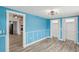 Bright bedroom with light blue walls, wood floors, and a ceiling fan at 126 90Th Ave, Treasure Island, FL 33706