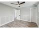 Bedroom with wood-look floors, white shutters, and ceiling fan at 126 90Th Ave, Treasure Island, FL 33706