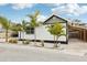Charming bungalow with white siding, gray roof, and lush landscaping at 126 90Th Ave, Treasure Island, FL 33706