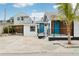 Modern home with blue door, gray roof, and carport at 126 90Th Ave, Treasure Island, FL 33706