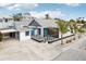 Newly renovated home with a modern deck, carport, and tropical landscaping at 126 90Th Ave, Treasure Island, FL 33706
