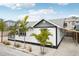 White house with black accents, tropical landscaping, and carport at 126 90Th Ave, Treasure Island, FL 33706