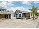 Modern beach cottage with a gray and white exterior, deck, and carport at 126 90Th Ave, Treasure Island, FL 33706