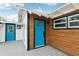 Modern home exterior with blue door and wood siding at 126 90Th Ave, Treasure Island, FL 33706