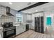 Updated kitchen with stainless steel appliances and patterned blue tile backsplash at 126 90Th Ave, Treasure Island, FL 33706